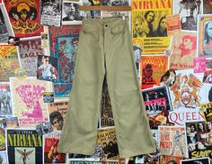 "Junior girls vintage 1970s khaki flares pants by 'A. Smile Inc.' Features welt flap pockets on front. We estimate it to fit a girls size 14 slim or 12 regular tall, but please check measurements as this is an estimate. Has two tiny stains on front + some dirt-wear marks on back {see images + video}. manufacturer | A. Smile Inc tag size | n/a -- est. it to fit girls size 14 slim *refer to measurements for accurate sizing measurements {taken laying flat}: waist -- 12.5\" hips -- 17\" rise -- 9.5\ Hippie Kids, 70s Girl, Mens 90s, Carhartt Workwear, Mens Workwear, Retro Girls, Utility Pants, Vintage Pants, Kids Pants