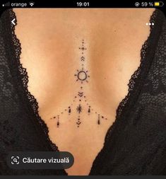 a woman's chest with an arrow and stars tattoo on her left side ribcage