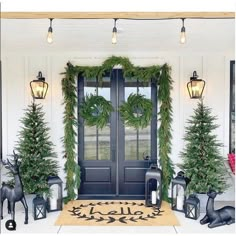 the front door is decorated with christmas trees and wreaths