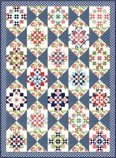 a blue quilt with many different designs on the front and back, all in various colors