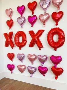 valentine's day balloons arranged in the shape of xoxo and heart shapes