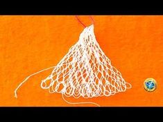 an orange t - shirt with a white net hanging from it's front pocket