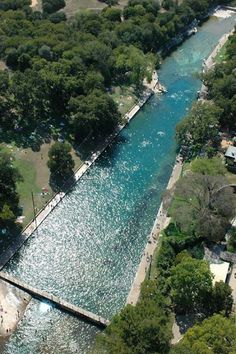 an aerial view of a river running through a city