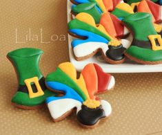 cookies decorated like hats and boots on a plate