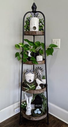 three tiered shelf with plants and decorations