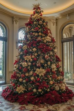 a large christmas tree with red and gold decorations