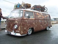 an old van with luggage on the roof