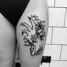 a woman's thigh with tattoos and words on it