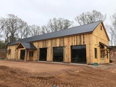 a large barn with two garages on top of it