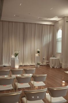 Beautiful wedding ceremony set up simple with white draped curtains, florals and candles Romantic Wedding Ceremony