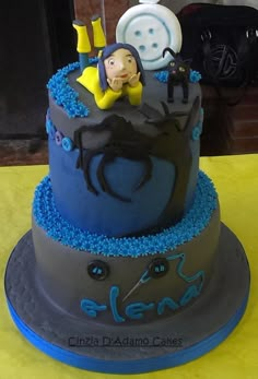 a blue and gray cake with people on it