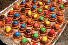 a tray filled with lots of candy covered pretzels