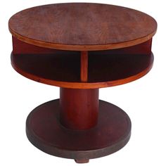 a round wooden table with two shelves on each side