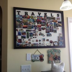 a wall covered in pictures and magnets next to a window