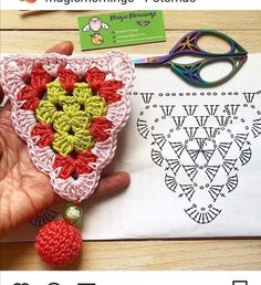 someone is crocheting an ornament with yarn and scissors on the table