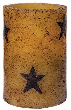 a yellow candle with black stars on it