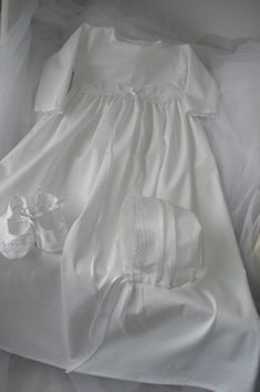 Baptismal gown r.68 3/cz COLOR white-made of cotton, trimmed with embroidery cotton -dress with long sleeves, fastened at the back with buttons Cap-bound -shoes All items trimmed with embroidery of cotton dimensions: length, ok.70cm, width 26 cm, sleeve 24 cm Classic White Dresses For Church, Classic White Baptism Dress For Church, Long Sleeve White Baptism Dress, Fitted First Communion Dress With Lace Trim For Church, Fitted Long Sleeve Baptism Dress With Lace Trim, White Classic Dresses For Church, Classic White Gown For First Communion, Classic White First Communion Gown, Embroidered Long Sleeve Baptism Dress