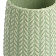 a green vase with wavy designs on it