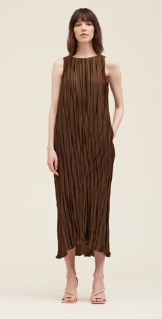 This pleated midi is such a gorgeous rich color. This simple silhouette is elevated with the beautiful pleated fabric with a little sheen and features pockets and a tie at the waist. Fabric & Care 100% Polyester Hand wash, Hang to dry Sizing True to size, relaxed fit. Palmer Alaska, Brown Midi Dress, Simple Silhouette, Swimming Outfit, Pleated Maxi Dress, Pleated Fabric, Pleated Maxi, Pleated Midi Dress, Loungewear Sets