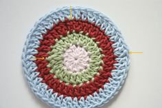 a crocheted circular is shown with the stitches marked in red, white and blue