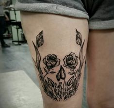 a woman's thigh with flowers and leaves on it