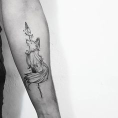 a woman's arm with a unicorn tattoo on the left side of her body