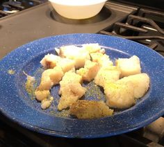 a blue plate filled with food on top of a stove