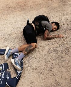 a man laying on the ground with his head down