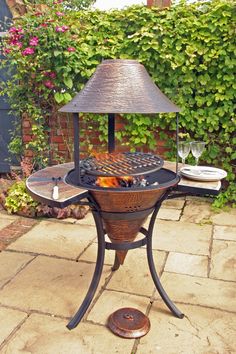 an outdoor grill with a lamp on top