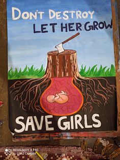 a sign that says don't destroy let her grow save girls with a tree stump in the background