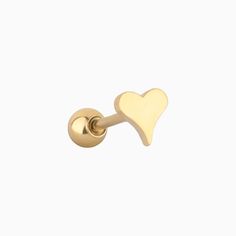 a pair of gold earrings with a heart on the front and back of each ear