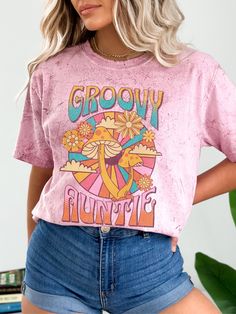 Groovy Auntie Color blast Tshirt for the grooviest aunt you know.  The Comfort Colors 1745 is a unisex, unique color blast t-shirt and any tee shirt maker's dream. Made 100% with incredibly soft, ring-spun cotton, each tee is soft-washed and garment-dyed. Its relaxed fit makes it the perfect daily choice for any casual occasion. .: 100% ring-spun cotton .: Medium fabric (6.1 oz/yd² (206.8 g/m .: Garment-dyed color blast fabric .: Relaxed fit .: Sewn-in twill label .: NB! Color Blast is a pigment Groovy Mama Shirt, Groovy Tshirt Design, Boho Tshirt Design, Groovy Tshirt, Aunt Tshirt, Hippie Mama, Groovy Mama, Boho Mom, Groovy Shirt