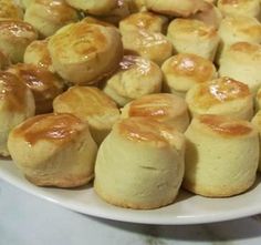 a white plate topped with rolls covered in caramel sauce