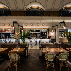 an empty restaurant with wooden tables and chairs