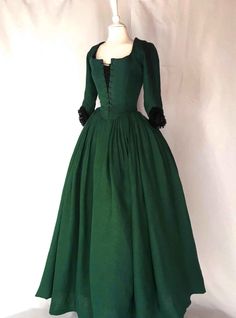 Immerse yourself in the grandeur of the past with our LOUISE, 18th-Century Dress in Dark Green Linen. This meticulously crafted garment is a faithful reproduction of the "English dress" popular in Western Europe and America during the period of 1770-1785. The rich, dark green color is reminiscent of the deep forests and regal elegance of the 18th century, making this dress a true historical treasure.This one-piece Gown is designed with an eye for detail and authenticity. The front opening featur Dark Green One Piece Dress, English Gown Styles, Green Victorian Dress, Georgian Dress, 18th Century Dresses, English Dress, Rococo Dress, Elizabeth Swann, Large Skirt