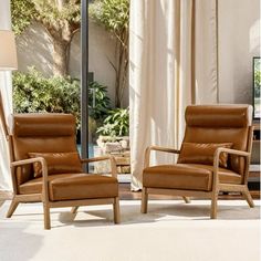 two brown leather chairs sitting in front of a window