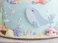 a blue cake decorated with sea animals and seashells