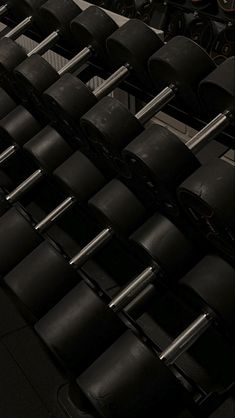 many black wheels are stacked on top of each other in a room filled with machines