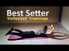 a man laying on top of a purple mat with a volleyball ball in his hand