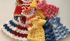 several crocheted baby bibs are arranged on a white surface with the words, crochet pattern dress potholder