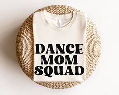 a t - shirt that says dance mom squad on it sitting on a wicker basket