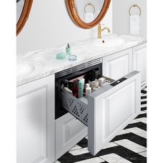 a bathroom with two sinks and a large mirror above the sink is an open drawer