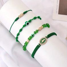 This 4 piece bracelet features traditional charm types from Mexico, including the Evil Eye, Mal de Ojo, San Judas Tadeo, and Pulsera. Each bracelet is handmade with care, and features a unique combination of green beads and a stretch clasp type for a comfortable fit. The round shape of the beads adds to the overall design, creating a stylish and meaningful piece of jewelry. The bracelet is perfect for those who appreciate the theme of luck, and is suitable for both men and women. The charm types are designed to bring good fortune and prosperity, making this a great addition to any jewelry collection. Made with authentic materials and a handmade touch, this bracelet is a must-have for anyone who values traditional Mexican culture. Evita mal de ojo, pulsera curado para proteger del mal de oj Green Ojo Bracelet, Mexican Bracelets, Saint Jude, Traditional Mexican, Green Beads, Mexican Culture, Eye Bracelet, Evil Eye Bracelet, Good Fortune