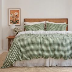 a bed with green and white checkered bedspread