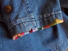 a button on the back of a jean jacket with candy canes attached to it