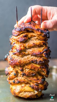 a stack of food that is on top of a metal pan with toothpicks sticking out of it