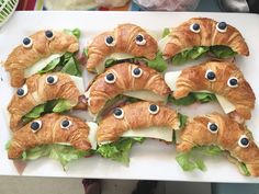 croissants with googly eyes are on a white platter, ready to be eaten