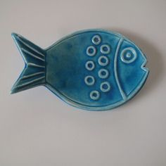 a blue ceramic fish dish sitting on top of a table