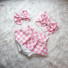 This Beautiful pink plaid print is perfect for your little dolls movie themed birthday party. Your little Sweetheart will be the star of the show when they are rocking this pink checker print outfit.  Now in skirted leggings to keep those little legs warm in the coolor seasons. Choose from adorable baby bummies (diaper cover), Skirted Bummies, Baby Bells, Bow on Nylon, Bow Headband, and more.  Liverpool fabric ensures longevity of the fit while being breathable. Stylish enough to wear for photo Cute Fitted Gingham Sets, Pink Cotton Sets For Gifts, Cute Pink Set With Matching Headband, Fun Pink Party Sets, Pink Cotton Sets With Matching Headband, Cute Pink Gift Sets, Playful Pink Sets With Matching Headband, Cute Plaid Playtime Sets, Cute Pink First Birthday Sets