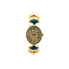 This original vintage Ladies Bueche Girod Watch is finely crafted in vibrant 18k yellow gold. The oval face of the dial features a chic Mid-Century modern design. Roman numerals define the hour markers. Featuring a manual wind movement manufactured by Bueche Girod, a small watchmaking company founded in 1947 by Vital Bueche and his wife Girod. It comes with a golden and green enamel bracelet strap measuring 6.5 inches long. A timepiece to treasure throughout the years. A one of a kind gift for y Luxury Gold Oval Watch, Luxury Oval Gold Watches, Classic Oval Gold Watches, Classic Yellow Gold Oval Watch, Classic Oval Yellow Gold Watch, Oval Quartz Watch For Formal Occasions, Yellow Gold Oval Watch For Gift, Elegant Oval Watches For Evening, Oval Yellow Gold Watches For Gifts